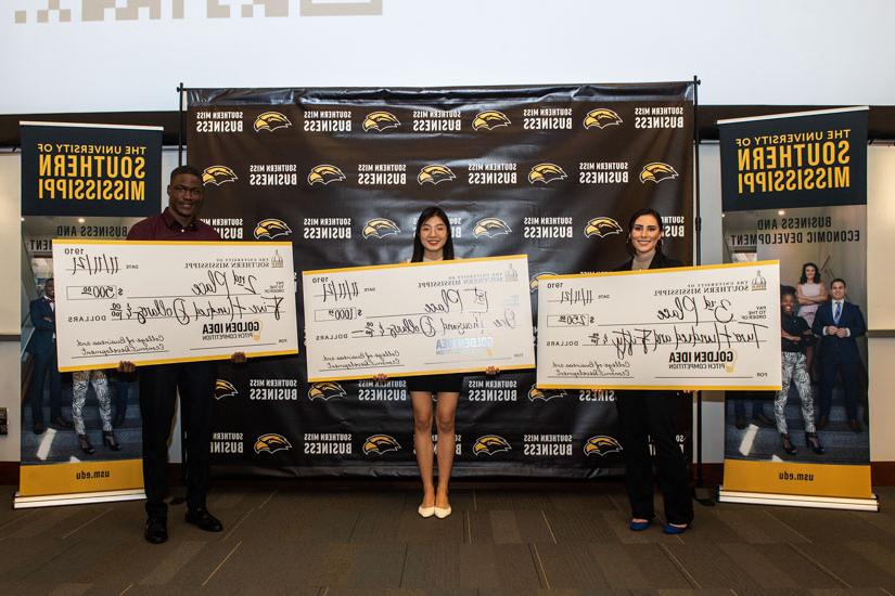 Students holding their winning checks